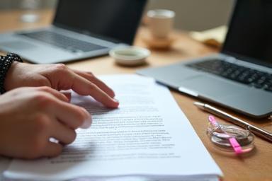 Hands working on a resume document